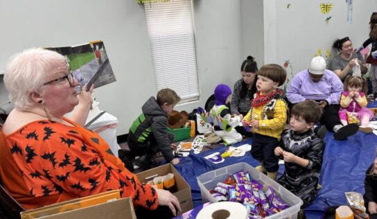 Children trick-or-treat through Millbrook Library during spooky story time